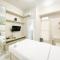 Minimalist and Homey Studio Room at Amartha View Apartment By Travelio - Semarang