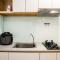 Minimalist and Warm 2BR Apartment M-Town Residence By Travelio