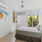 Newly Renovated Beachfront Condo with Inviting Minimalist Design, Pool & Balcony with Ocean Views