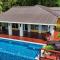 Relax At This Hillside Retreat That Overlooks The Lush Forest And The Caribbean,