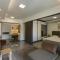 One-Bedroom Apartment and Luxury Penthouse in a Poolside Complex