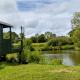 Charming tranquil Shepherds Hut with lakeside balcony 'Roach', Uckfield