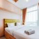 Homey and Modern Studio at Tree Park City Cikokol Apartment By Travelio