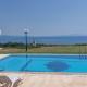 Blue Pastel-cliffside villa, shared pool, wild sandy beach nearby