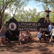 a group of people posing in front of a national park