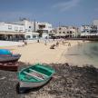 a beach with two boats sitting on the sand