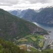 an aerial view of a mountain with a body of water