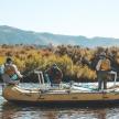 a group of three people in a raft on a river