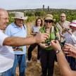 a group of people standing around a man holding a plant