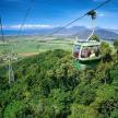 a group of people riding a gondola over a mountain