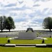 a large monument in a field with grass and trees