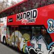 a red double decker bus with graffiti on it