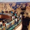 people on a viewing deck at the grand canyon