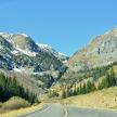 an empty road with mountains in the background