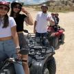 a group of people riding atvs in the desert
