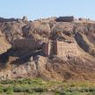 a rocky hillside with a mountain in the desert