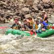 a group of people in a raft on a river