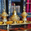 two gold urns sitting on top of a table
