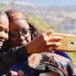 two women taking a picture with a cell phone