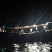 a boat in the water at night with lights
