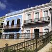 a row of houses with balconies and a fence