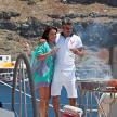 a man and a woman standing on a boat