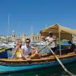 a group of people sitting on a boat in the water
