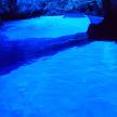 a river lit up in blue at night