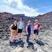 a group of people standing on a rocky mountain