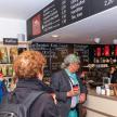 a group of people standing at a counter in a store