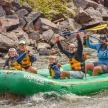 a group of people in a raft on a river