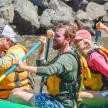 a group of people in a raft on a river