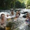 a group of people sitting in a river
