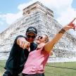 a man and woman posing in front of the pyramid