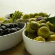 a group of bowls of olives on a table