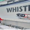a group of people standing in the snow in front of a wildeline boat