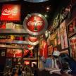 a group of people in a bar with cocacola signs