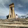 a girl standing on some steps in front of a monument