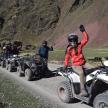 a group of people riding atvs on a mountain road