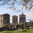 a picnic table in front of a building with two towers