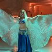 a woman in a blue dress with wings on a runway