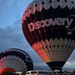 a group of hot air balloons in a field