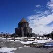an old building with a tower in the snow