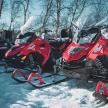 a row of motorcycles parked in the snow