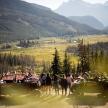 a group of people standing on a dirt road