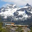 a house on top of a mountain with snow
