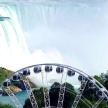 a roller coaster in front of a waterfall