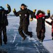 a group of people jumping on the ice