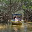 a group of people riding in a boat in a river