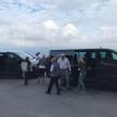 a group of people standing outside of a van